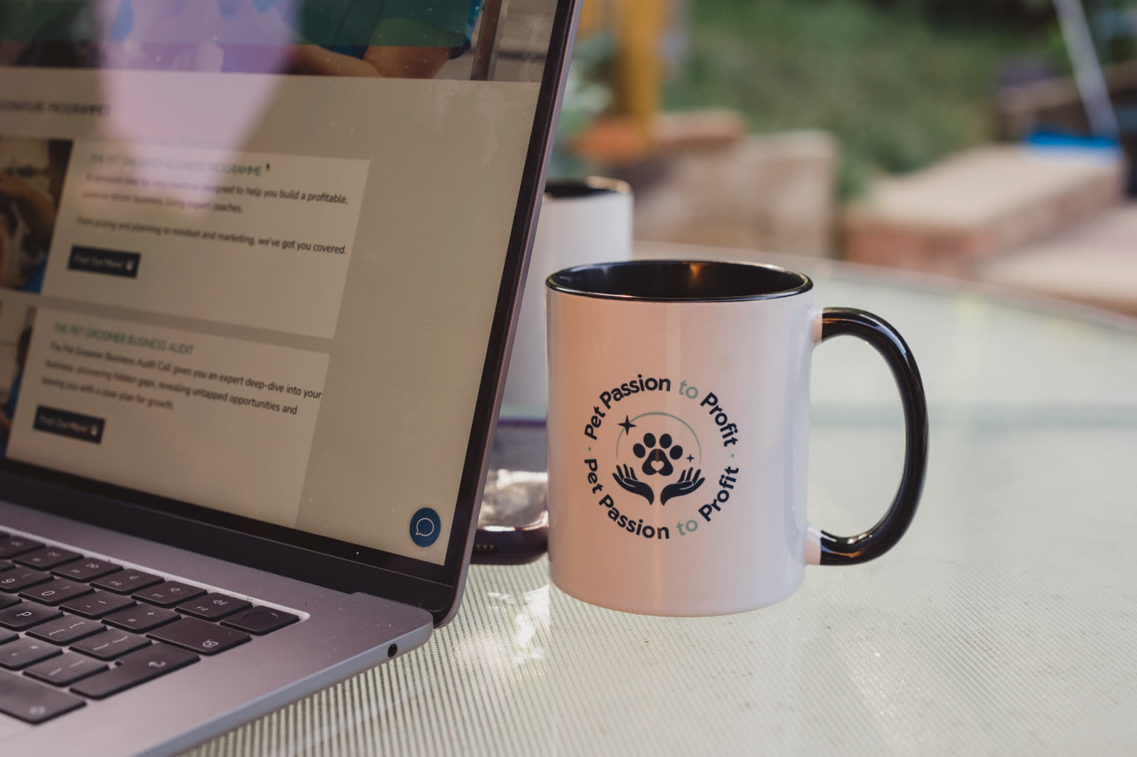 Pet Passion to Profit branded mug beside a laptop