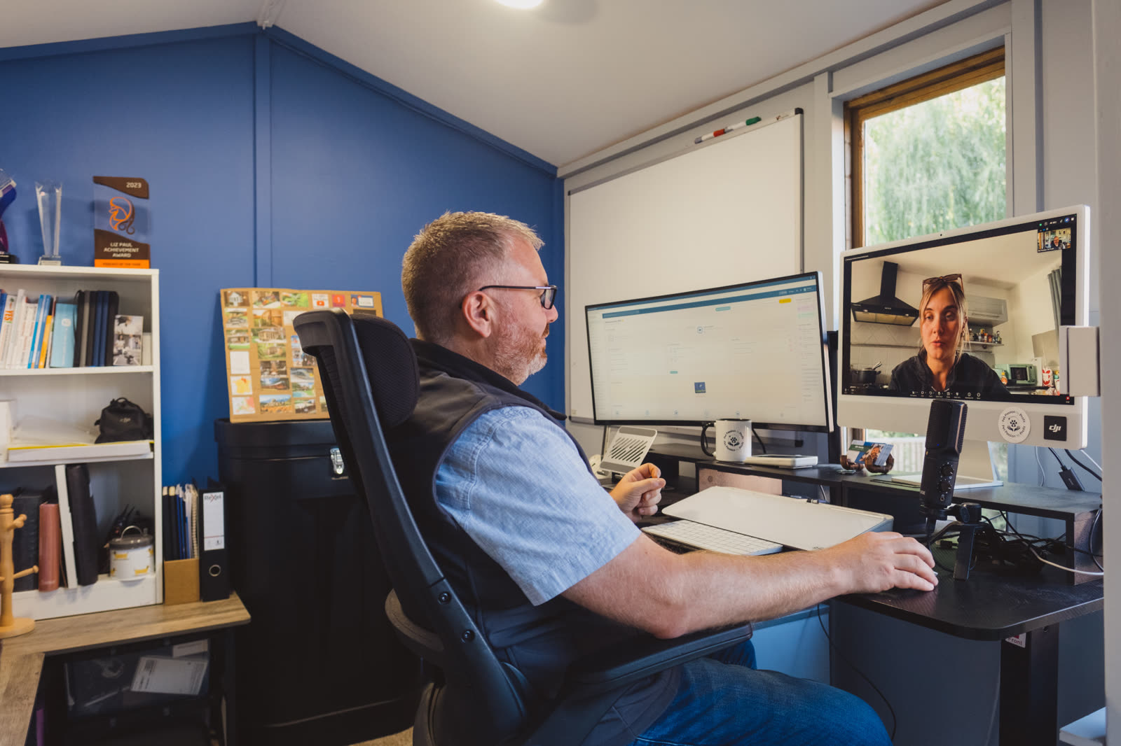 Bill working at his desk on a video call with a client